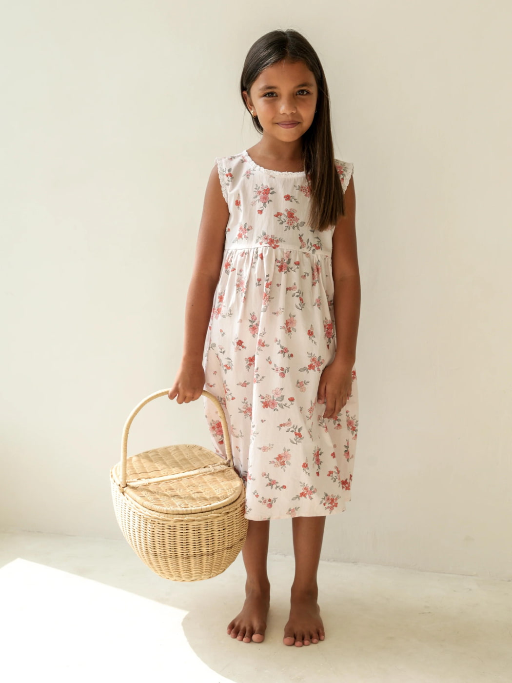 A girl wearing Illoura the label holding a basket