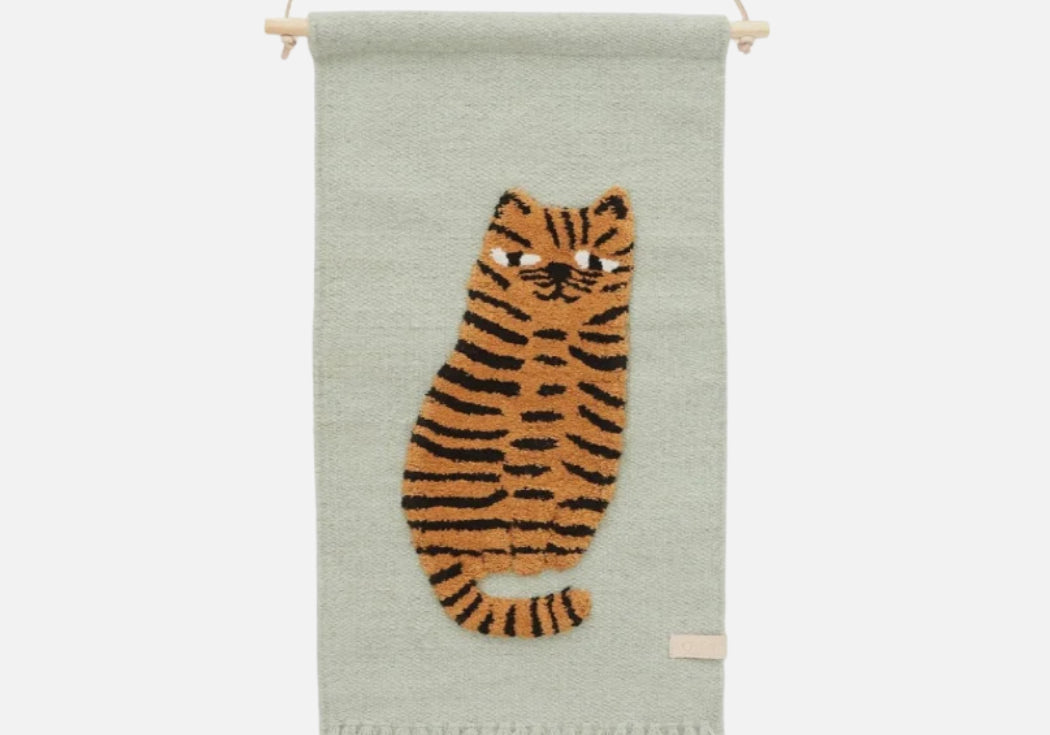 Woven wall hanging with a tiger design on a light green background